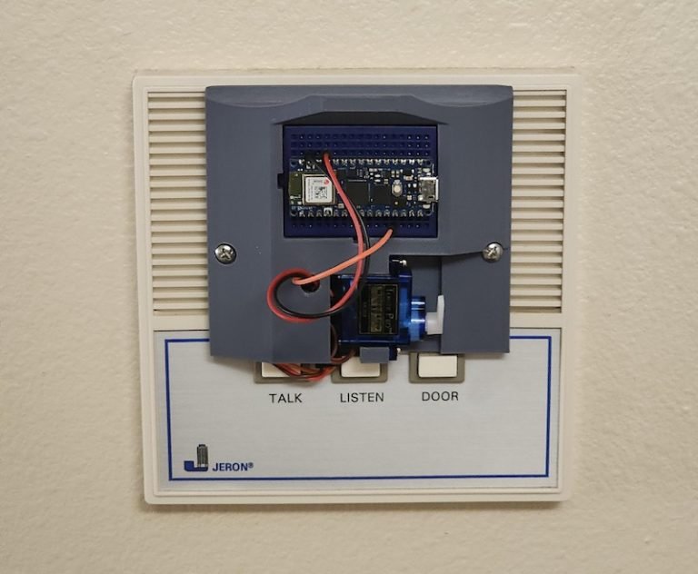 This simple intercom device unlocks an apartment building front door