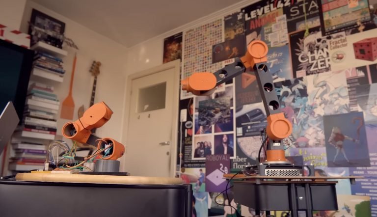 Micro robot arm controls macro robot arm